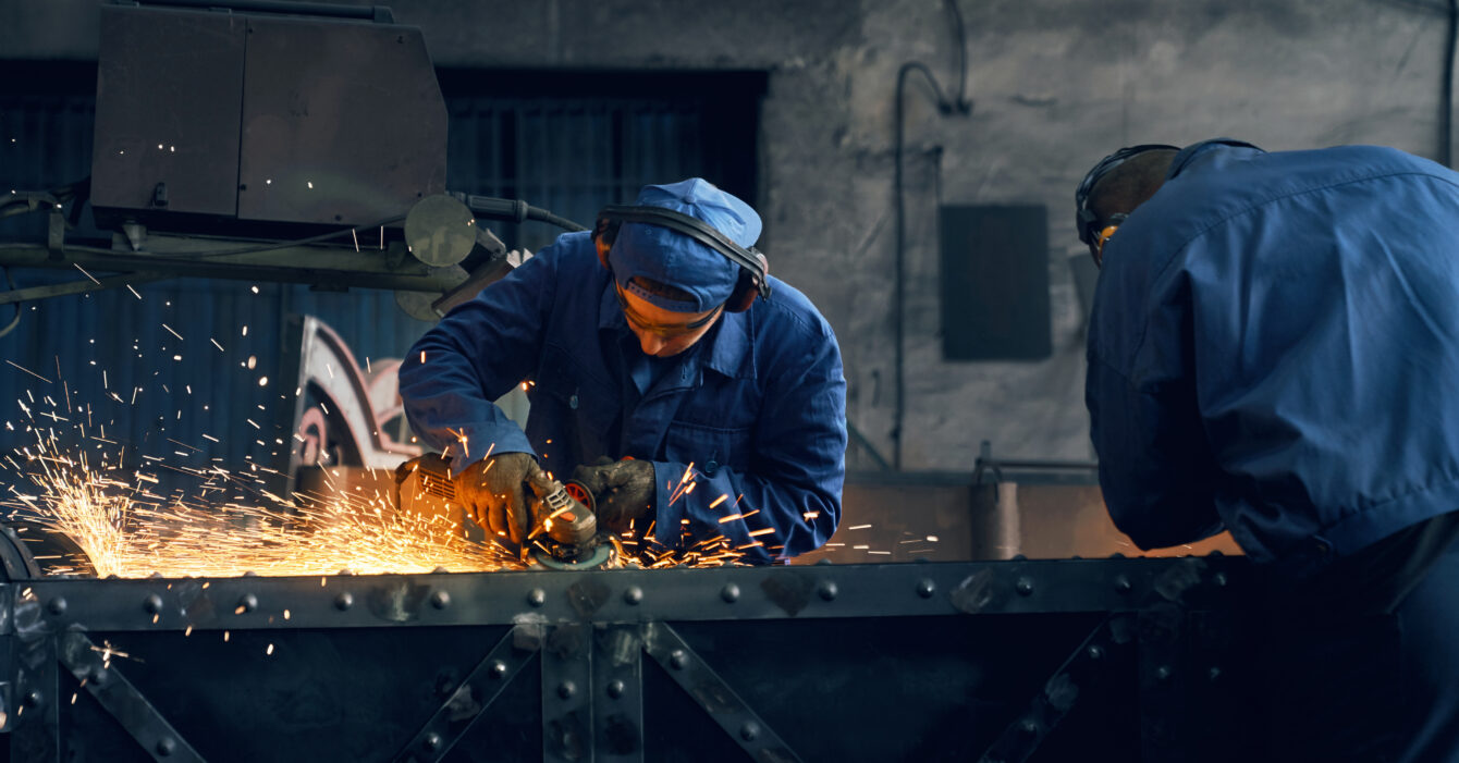 Two worker making gates in smithy.