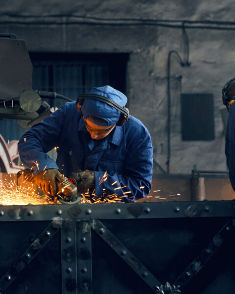 Two worker making gates in smithy.